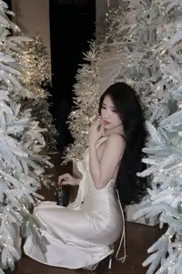 Christmas Muse: Elegant Beauty in a Backless Satin Dress by a Sparkling Tree-15