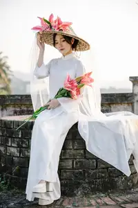 Discover the captivating grace of a Vietnamese woman in a flowing white Ao Dai and traditional conical hat-19