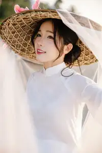 Discover the captivating grace of a Vietnamese woman in a flowing white Ao Dai and traditional conical hat-0