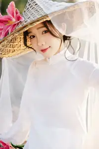 Discover the captivating grace of a Vietnamese woman in a flowing white Ao Dai and traditional conical hat-25