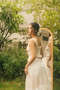 Dreamy Reflection: Girl in white dress finds gentle elegance in a garden mirror.-0