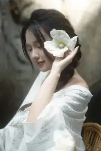 Serene Asian Beauty: A Delicate Moment with a White Flower-0