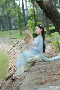 Elegant Vietnamese Maiden in Áo Dài Amidst Serene Nature's Embrace-3