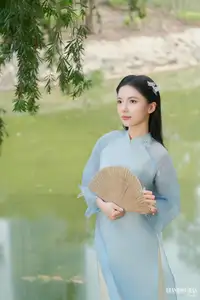 Elegant Vietnamese Maiden in Áo Dài Amidst Serene Nature's Embrace-1