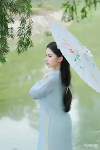 Elegant Vietnamese Maiden in Áo Dài Amidst Serene Nature's Embrace-5