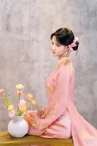 Elegant Asian Charm: Serene Young Woman in Traditional Pink Attire with Delicate Fresh Flowers-2