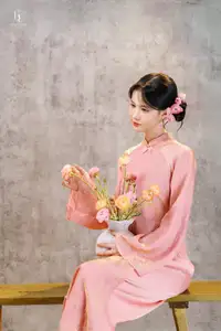 Elegant Asian Charm: Serene Young Woman in Traditional Pink Attire with Delicate Fresh Flowers-0