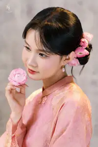Elegant Asian Charm: Serene Young Woman in Traditional Pink Attire with Delicate Fresh Flowers-1