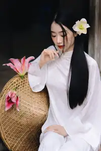 Discover the Grace of a Vietnamese Woman in White Ao Dai with Elegant Lilies-2