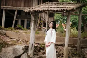 Timeless Elegance: Vietnamese Woman in Traditional Ao Dai Amidst Serene Backdrop-8