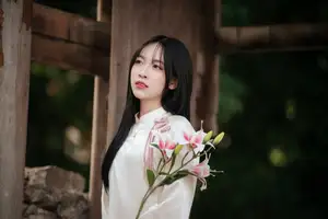 Timeless Elegance: Vietnamese Woman in Traditional Ao Dai Amidst Serene Backdrop-12