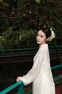 Gentle Elegance: Vietnamese Girl in Pure White Ao Dai with Hair Flowers - Traditional Beauty.-0