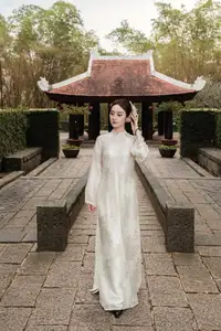 Gentle Elegance: Vietnamese Girl in Pure White Ao Dai with Hair Flowers - Traditional Beauty.-4