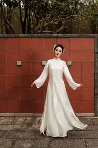 Gentle Elegance: Vietnamese Girl in Pure White Ao Dai with Hair Flowers - Traditional Beauty.-7