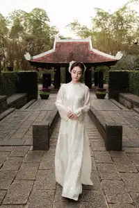 Gentle Elegance: Vietnamese Girl in Pure White Ao Dai with Hair Flowers - Traditional Beauty.-3