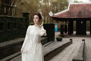 Gentle Elegance: Vietnamese Girl in Pure White Ao Dai with Hair Flowers - Traditional Beauty.-8