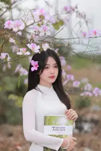Elegant Vietnamese Student in Ao Dai Amidst Bauhinia Flowers-0