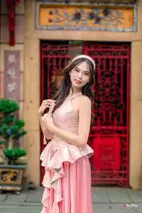 Graceful Woman in Pink Dress Amidst Ancient Heritage Charm 1000025280-0