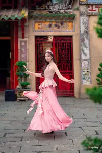 Graceful Woman in Pink Dress Amidst Ancient Heritage Charm 1000025280-4