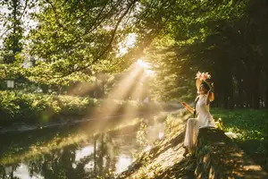 Serene Vietnamese Beauty in White Ao Dai with Lilies: A Golden Hour Portrait 1000025192-5