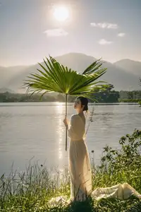 Golden Hour Serenity: Woman in White Dress Embracing Nature's Beauty by the Lake at Sunset.-10