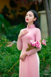 Graceful Vietnamese Woman in Pink Ao Dai: A Stunning Portrayal of Traditional Asian Beauty 1000019457-10