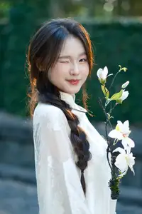 Pure Charm: White-Dressed Girl Winking Playfully with White Flowers 1000024585-2