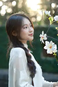 Pure Charm: White-Dressed Girl Winking Playfully with White Flowers 1000024585-3