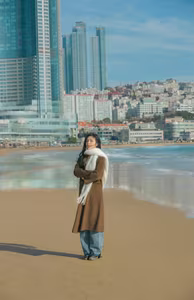 VGU No.81: Elegant Woman on a Winter Beach: A Pensive Moment of Style and Serenity.-1