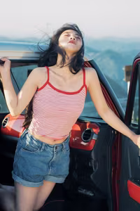 VGU No.128: Summer vibes: Young woman relaxed on a red car, captivating free spirit-9