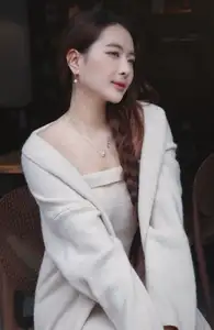 Discover the elegant charm of a gentle woman captured in a serene, thoughtful moment 176403855-0