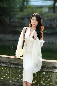 Elegant Beauty in Pristine White Dress Under Golden Afternoon Sun 1000027006-5