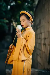 Discover the Graceful Beauty of a Vietnamese Woman in Radiant Yellow Ao Dai with Pure Lotus 1000025235-6