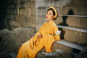 Discover the Graceful Beauty of a Vietnamese Woman in Radiant Yellow Ao Dai with Pure Lotus 1000025235-2