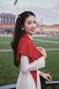 VGU No.110: Elegant White Ao Dai Amidst Red Flags, Celebrating Vietnamese Grace and Patriotism.-5