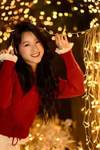 Radiant Smile Girl in Red Amidst Twinkling Lights: Warm Beauty for Festive Season-4