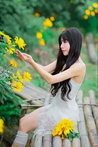 Graceful Young Woman in White Dress Amidst Vibrant Yellow Flowers 1000026997-2