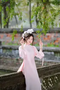 Elegant Vietnamese Beauty: Young Woman Gracefully Posing in Pink Ao Dai with White Orchids 1000026874-12