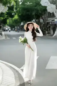 Vietnamese Schoolgirl Gracefully in Pure White Ao Dai Traditional Conical Hat and Lilies-0